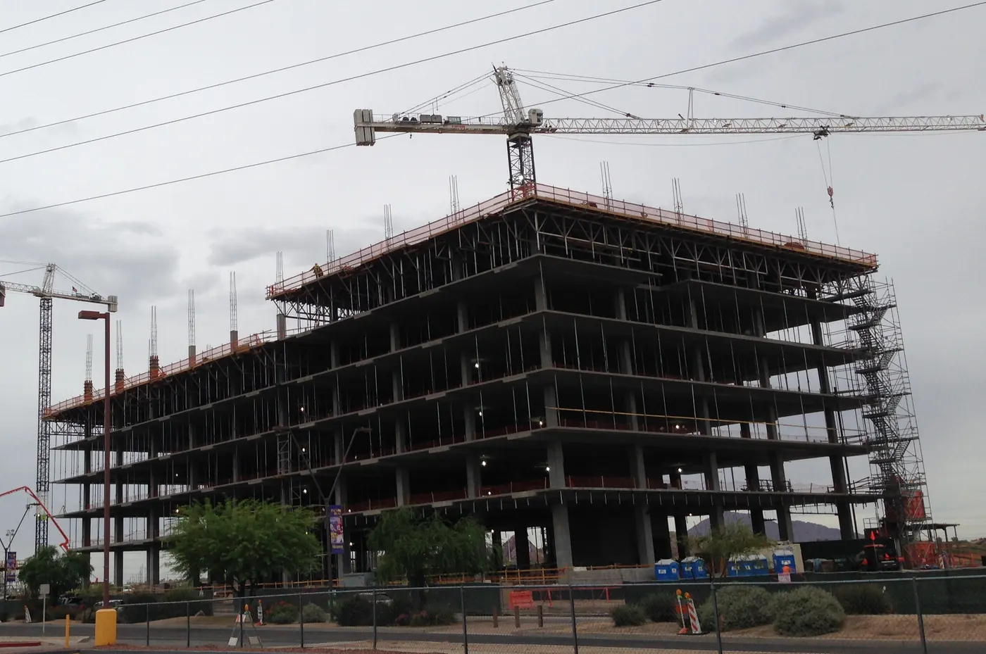 Mid-rise concrete frame under construction with tower cranes, Tempe, Phoenix metro